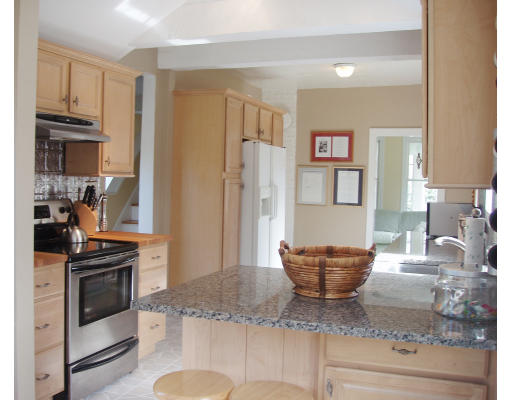 245 First Parish Road Scituate, MA 02066 - Photo 5 of 19 a living room with stainless steel appliances granite countertop a stove a refrigerator and a sink