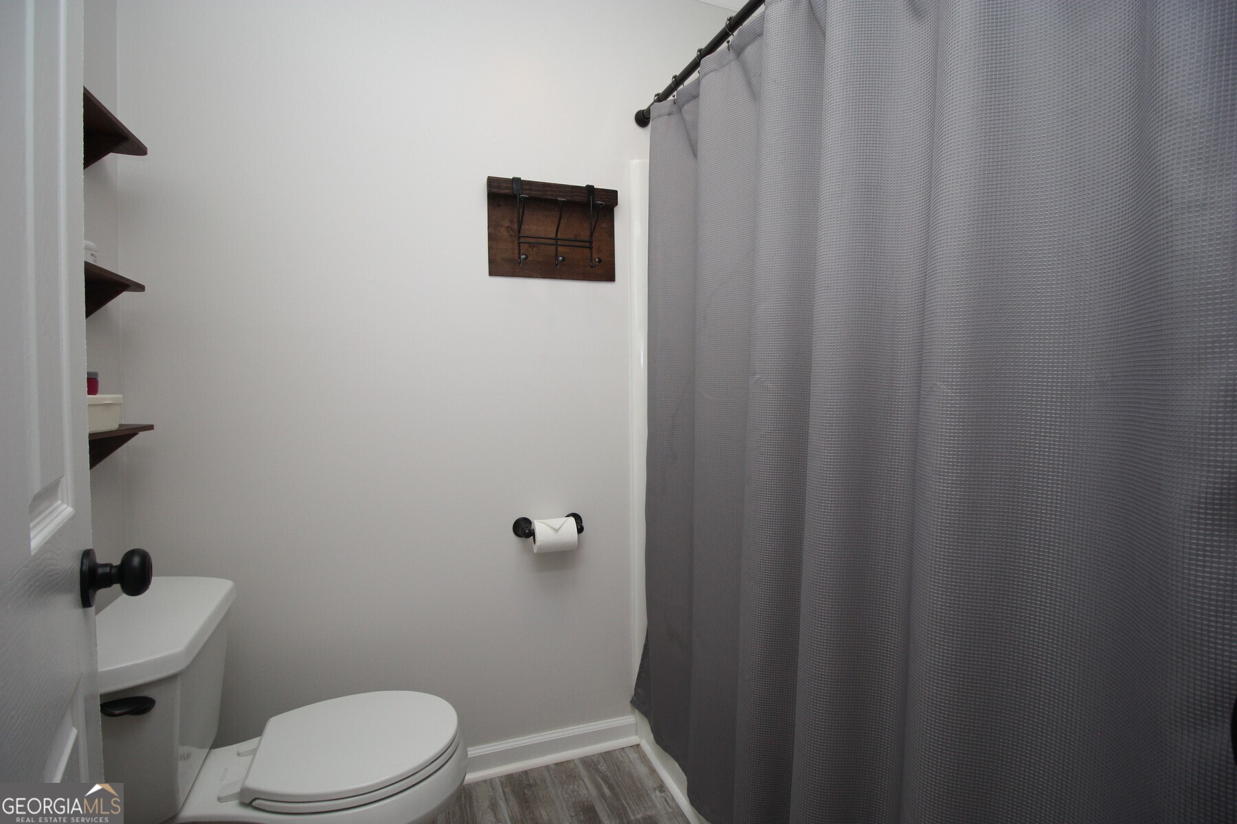 231 Murphy Road LaGrange, GA 30240 - Photo 16 of 24 a bathroom with a toilet and a shower curtain