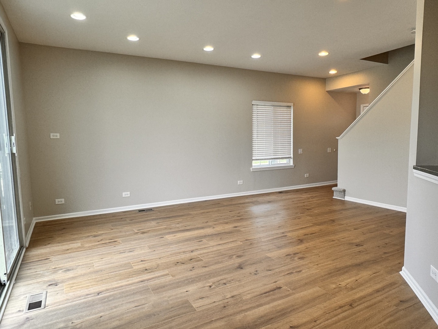 1617 Spaulding Road Bartlett, IL 60103 - Photo 3 of 9 an empty room with wooden floor and windows