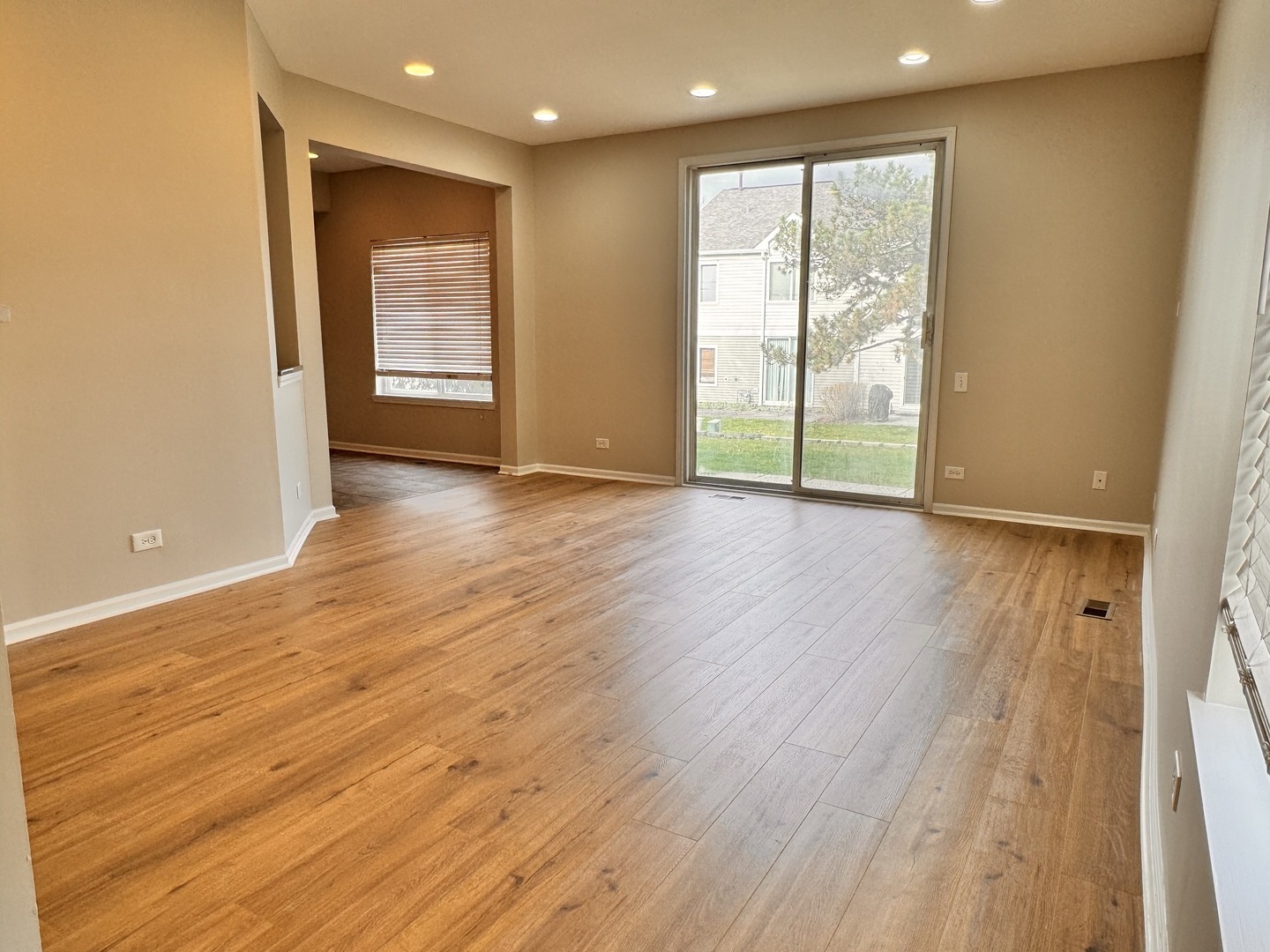 1617 Spaulding Road Bartlett, IL 60103 - Photo 4 of 9 an empty room with wooden floor and sliding door