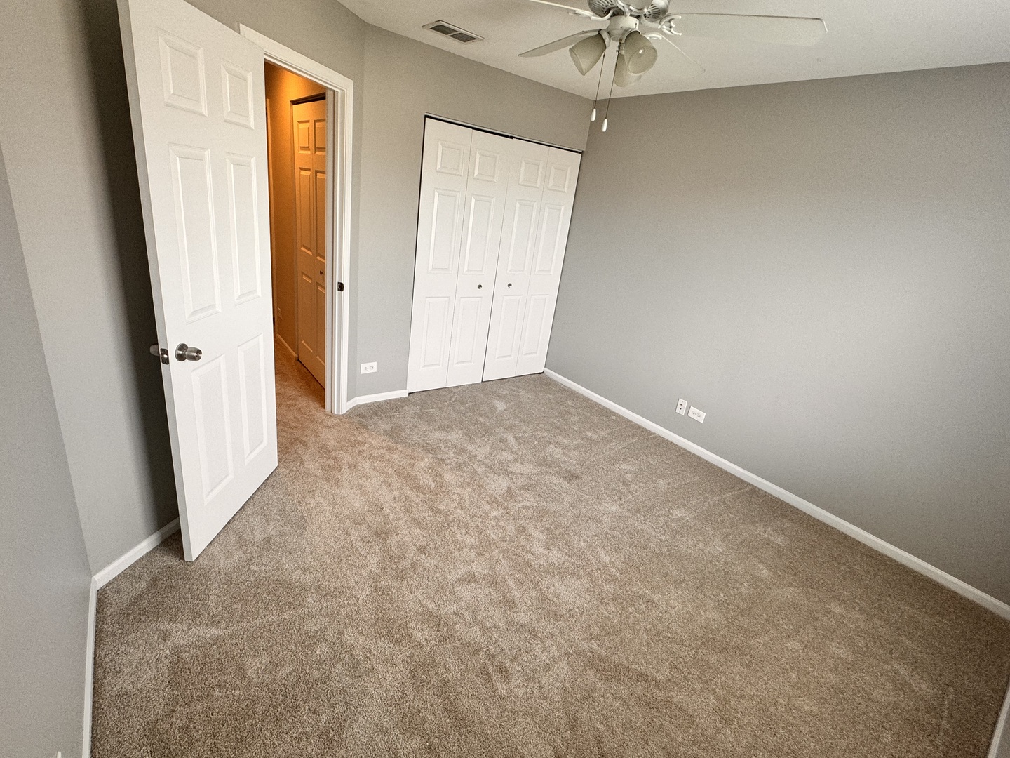 1617 Spaulding Road Bartlett, IL 60103 - Photo 7 of 9 an empty room with a window and a chandelier fan