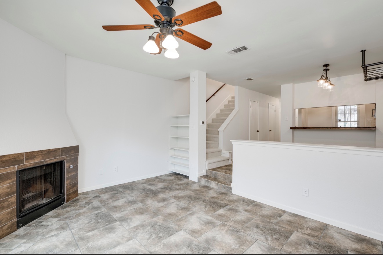 11821 Bittern Hollow, Unit 34 Austin, TX 78758 - Photo 14 of 29 Unfurnished living room with a tile fireplace and ceiling fan