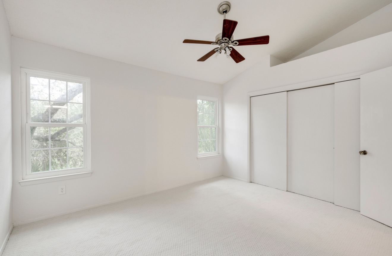 11821 Bittern Hollow, Unit 34 Austin, TX 78758 - Photo 22 of 29 Unfurnished bedroom featuring carpet flooring, lofted ceiling, ceiling fan, and a closet