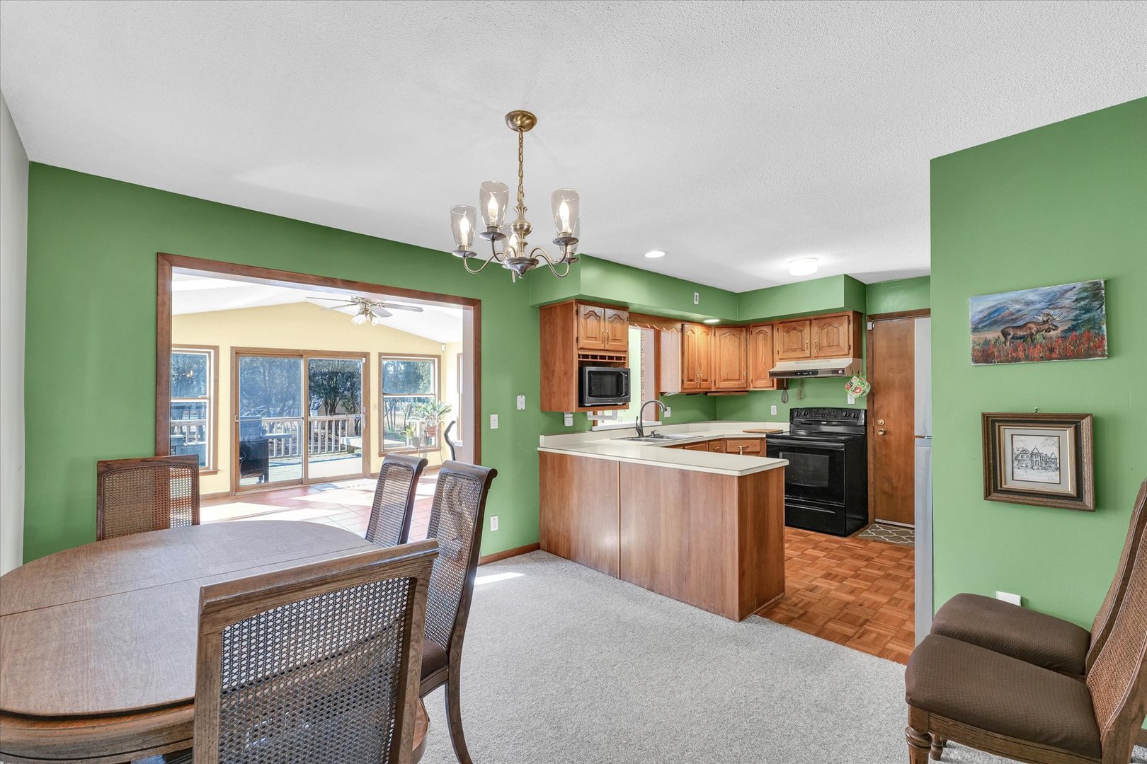 586 Hazelcrest Place Rantoul, IL 61866 - Photo 11 of 47 a dining room with furniture and a chandelier