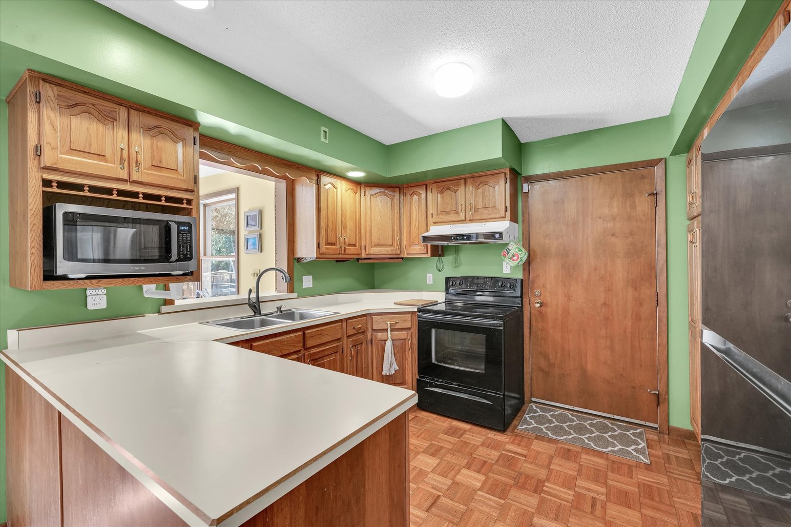 586 Hazelcrest Place Rantoul, IL 61866 - Photo 13 of 47 a kitchen with stainless steel appliances granite countertop a stove a sink and a microwave