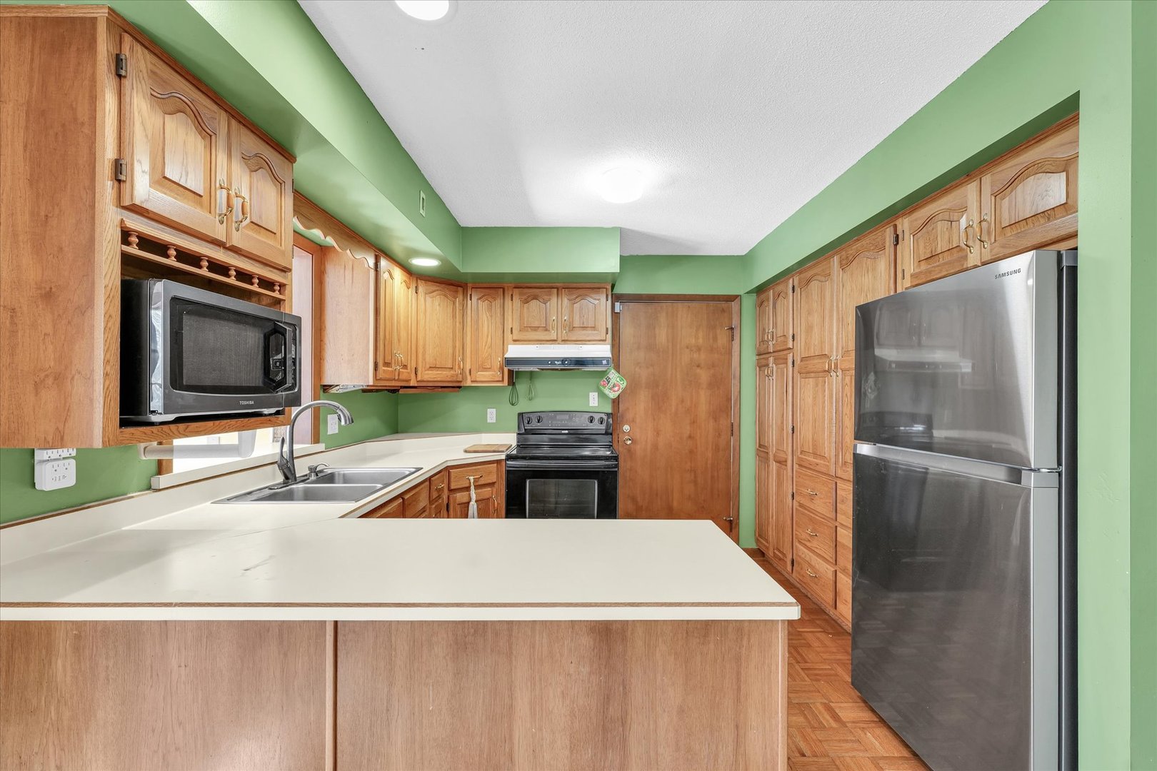 586 Hazelcrest Place Rantoul, IL 61866 - Photo 14 of 47 a kitchen with stainless steel appliances kitchen island granite countertop a refrigerator and a sink