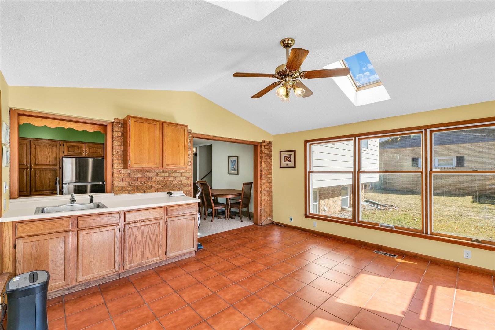 586 Hazelcrest Place Rantoul, IL 61866 - Photo 19 of 47 a large white kitchen with a large window and stainless steel appliances