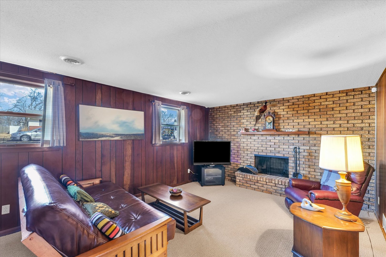586 Hazelcrest Place Rantoul, IL 61866 - Photo 30 of 47 a living room with furniture a fireplace and a flat screen tv