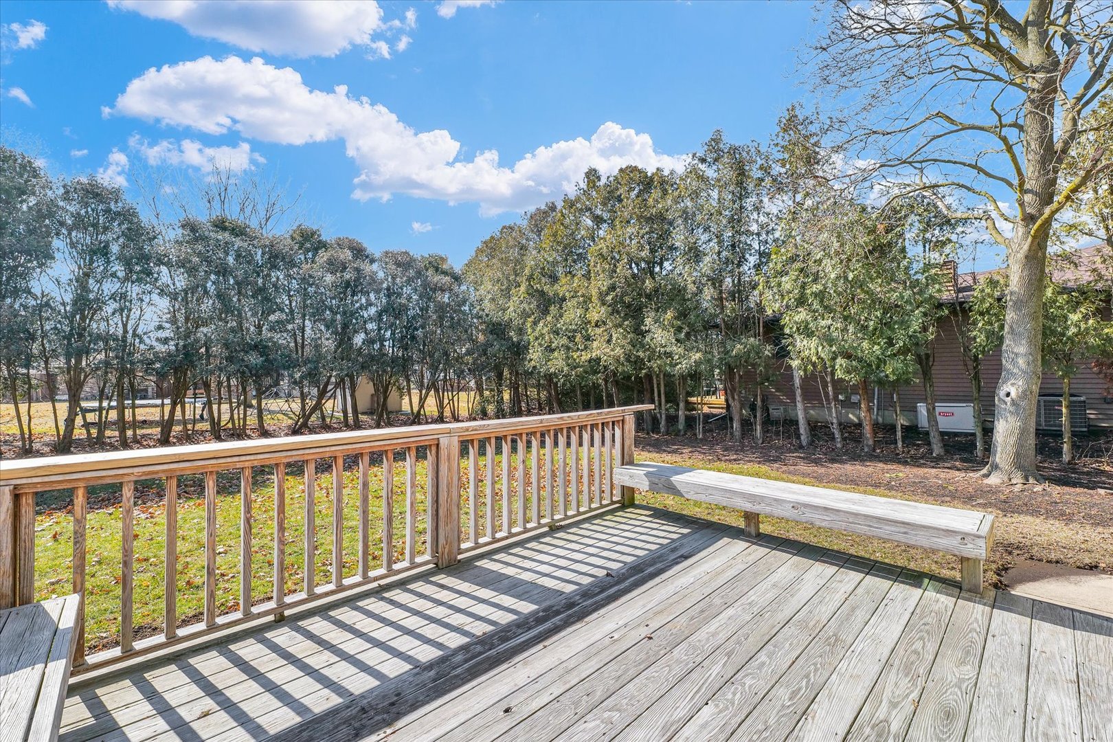 586 Hazelcrest Place Rantoul, IL 61866 - Photo 46 of 47 a view of balcony with wooden floor and trees