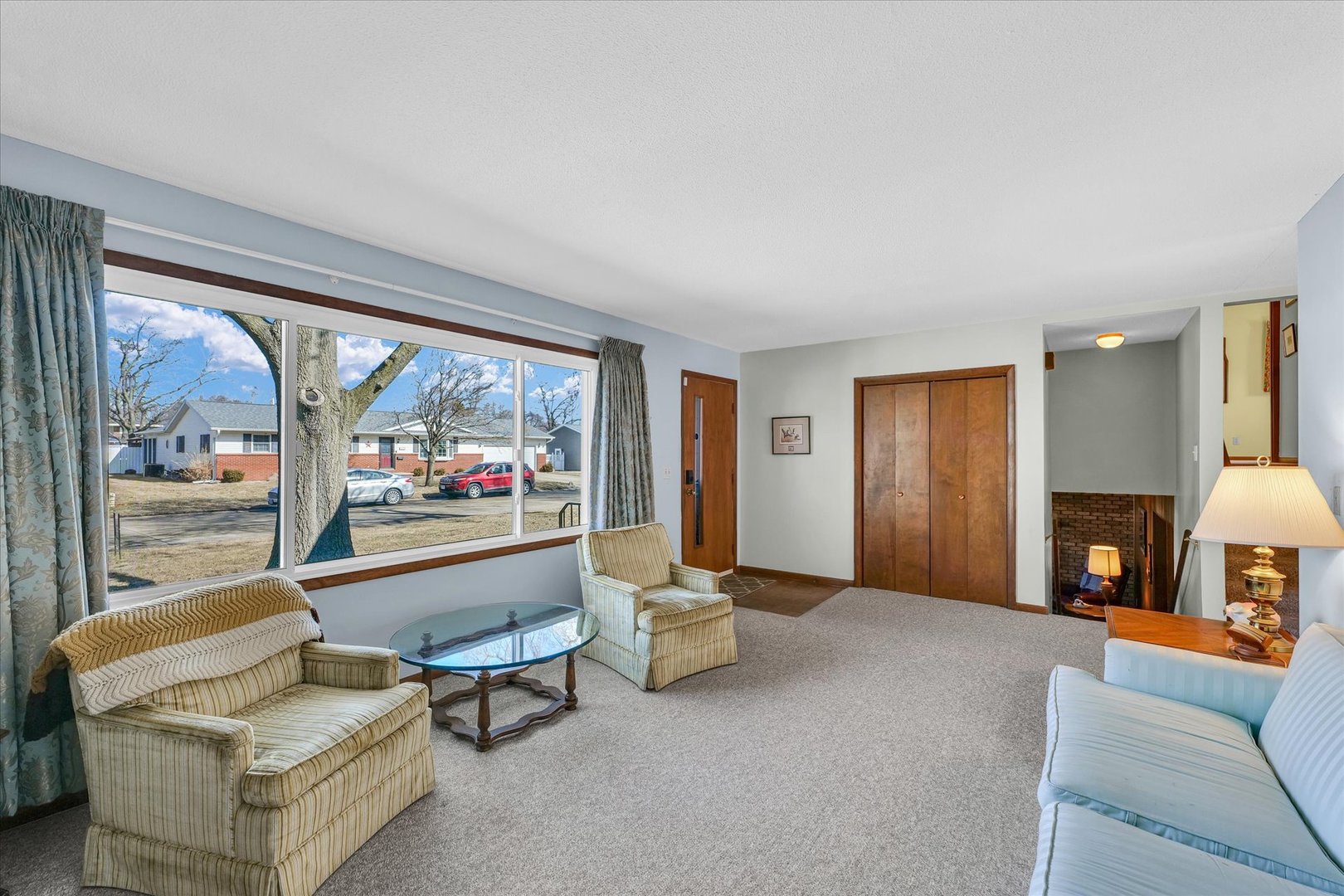 586 Hazelcrest Place Rantoul, IL 61866 - Photo 10 of 47 a living room with furniture a fireplace and a large window