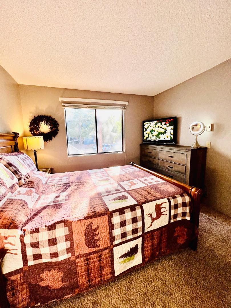 2600 South White Mountain Road Show Low, AZ 85901 - Photo 12 of 23 a bedroom with a bed lamp closet and window