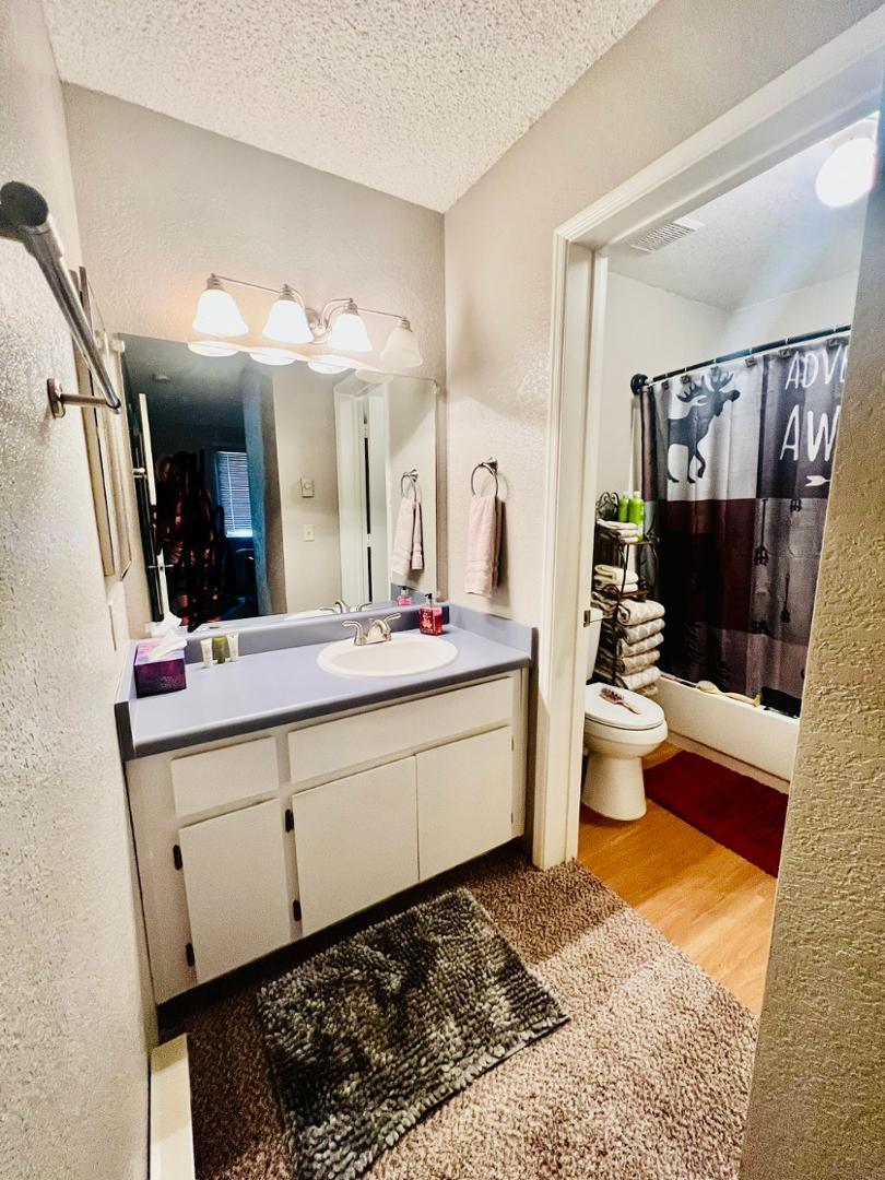 2600 South White Mountain Road Show Low, AZ 85901 - Photo 15 of 23 a bathroom with a double vanity sink a toilet a mirror and shower