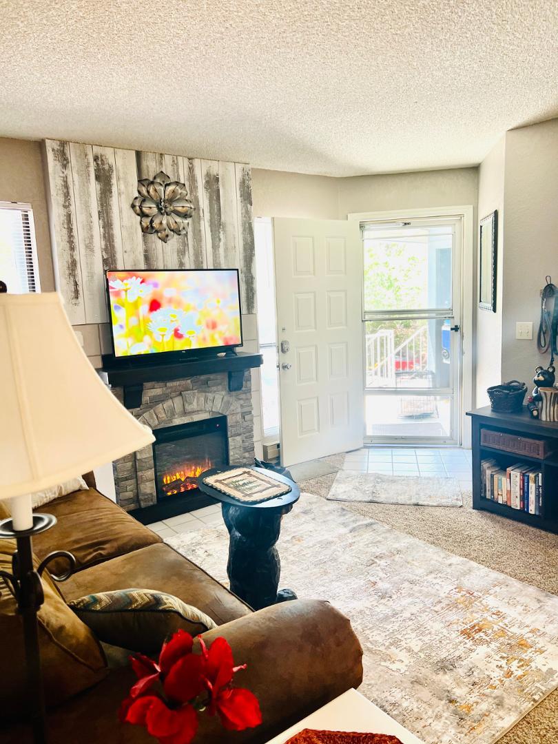 2600 South White Mountain Road Show Low, AZ 85901 - Photo 4 of 23 a living room with furniture a flat screen tv and a fireplace
