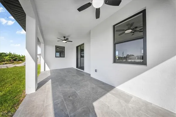 a view of livingroom with furniture ceiling fan and window