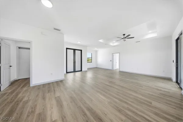 a view of an empty room with wooden floor