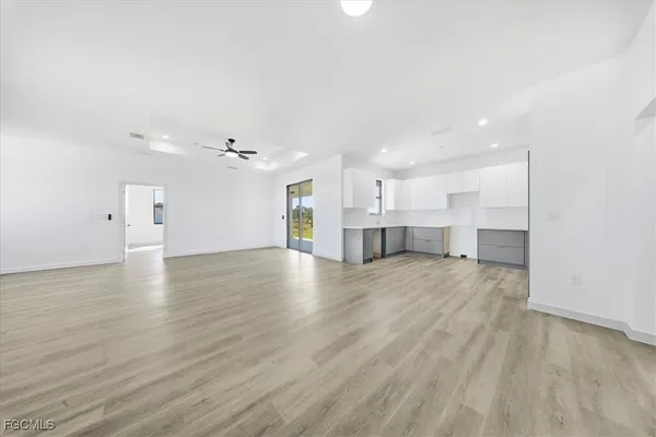a view of kitchen and hall with wooden floor