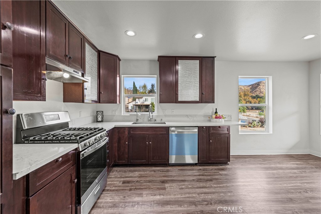 28637 Chiquito Canyon Road Castaic, CA 91384 - Photo 13 of 74 a kitchen with stainless steel appliances granite countertop a stove a sink and a microwave