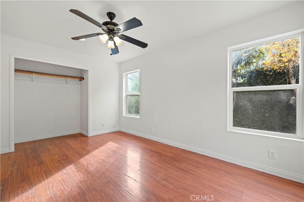 28637 Chiquito Canyon Road Castaic, CA 91384 - Photo 16 of 74 a view of empty room with wooden floor and fan