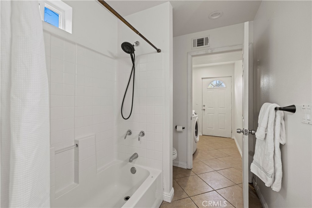 28637 Chiquito Canyon Road Castaic, CA 91384 - Photo 19 of 74 a bathroom with a bath tub with a shower
