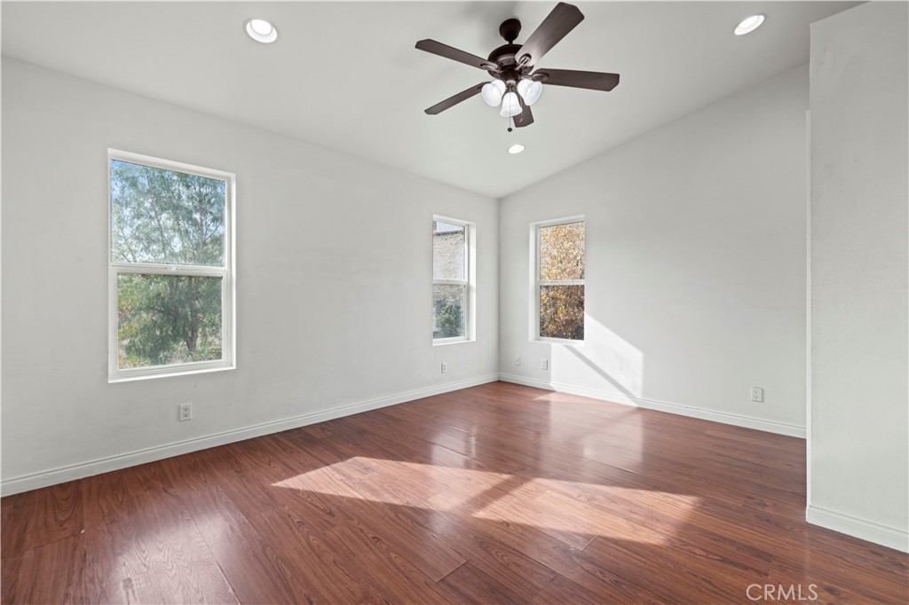 28637 Chiquito Canyon Road Castaic, CA 91384 - Photo 26 of 74 a view of an empty room with wooden floor and a window