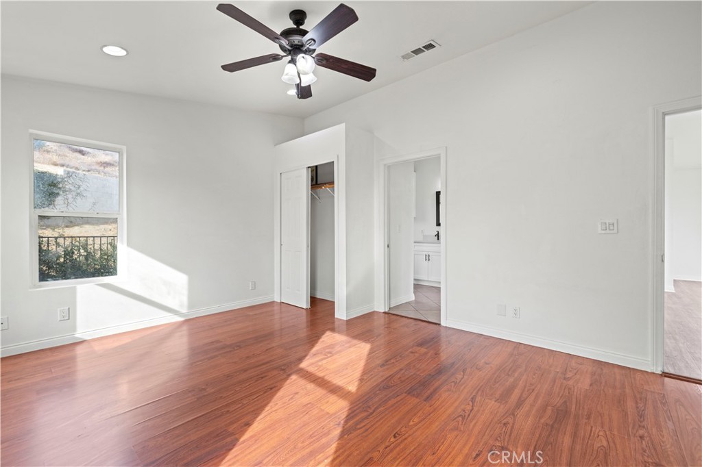 28637 Chiquito Canyon Road Castaic, CA 91384 - Photo 28 of 74 an empty room with wooden floor and windows
