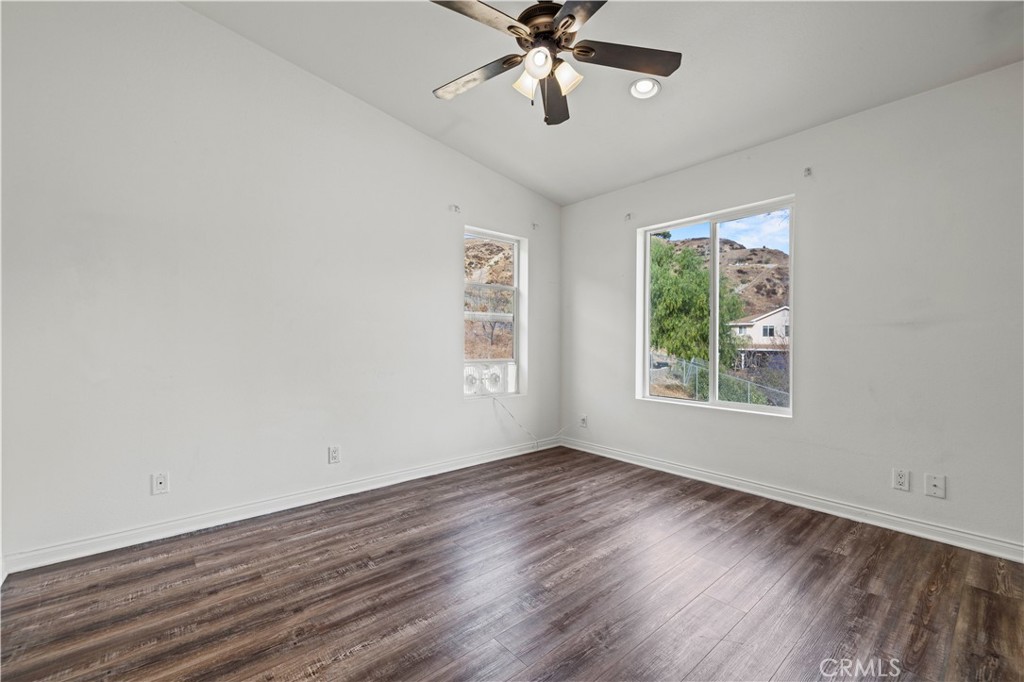 28637 Chiquito Canyon Road Castaic, CA 91384 - Photo 31 of 74 a view of an empty room with wooden floor and a window