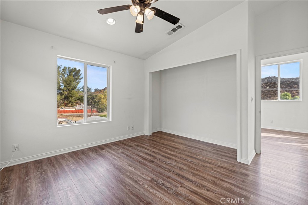 28637 Chiquito Canyon Road Castaic, CA 91384 - Photo 32 of 74 a view of an empty room with wooden floor and a window