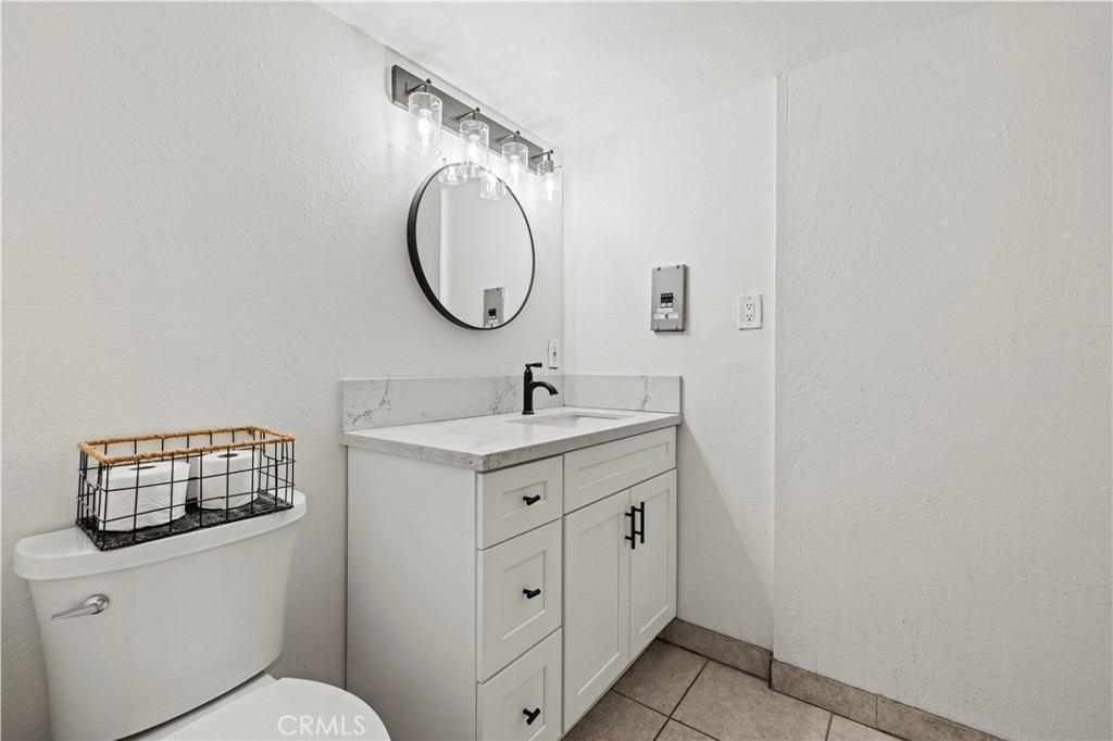 28637 Chiquito Canyon Road Castaic, CA 91384 - Photo 40 of 74 a bathroom with a sink a toilet and a mirror