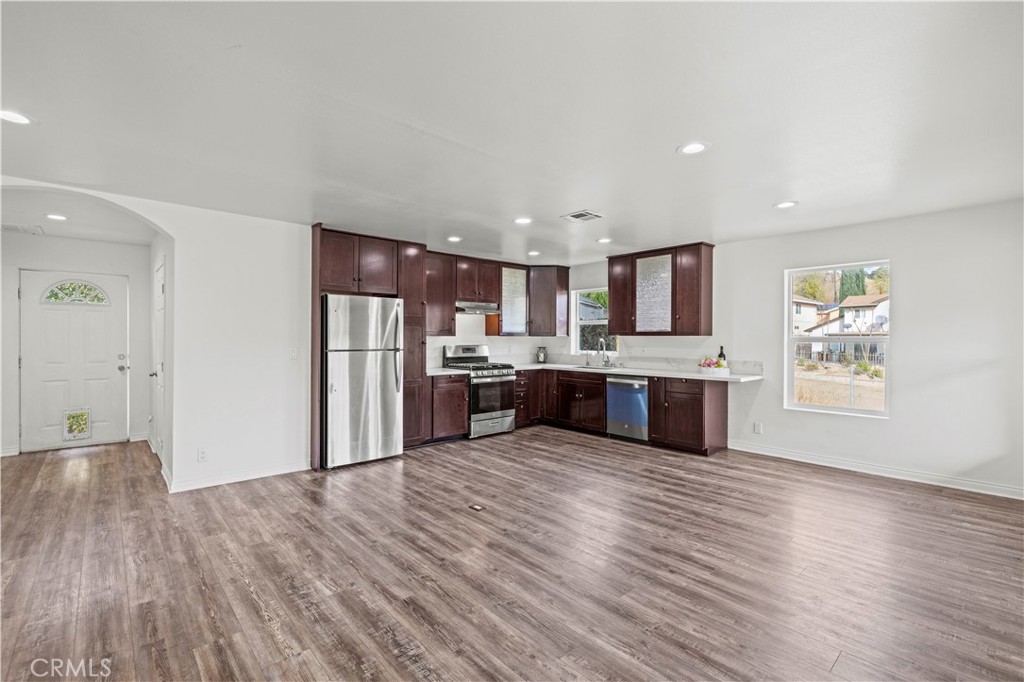 28637 Chiquito Canyon Road Castaic, CA 91384 - Photo 9 of 74 a kitchen with stainless steel appliances granite countertop a refrigerator sink and wooden floor