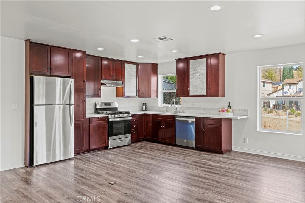 28637 Chiquito Canyon Road Castaic, CA 91384 - Photo 10 of 74 a large kitchen with stainless steel appliances granite countertop a refrigerator and a stove top oven