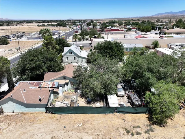 an aerial view of a house with a yard basket ball court and outdoor seating