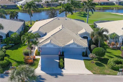 a aerial view of a house with a yard and potted plants