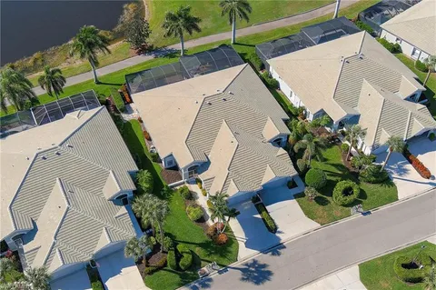 an aerial view of a house with a yard and a wooden bench