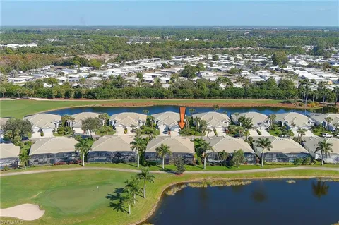 an aerial view of a residential houses with outdoor space and lake view