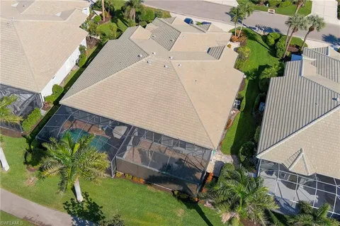 an aerial view of a house with a yard and potted plants