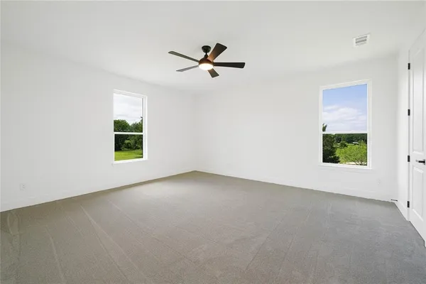 an empty room with windows and closet
