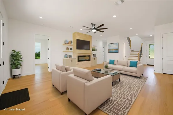 a living room with furniture a table and a fireplace