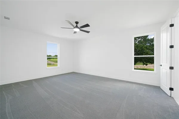 a kitchen with stainless steel appliances kitchen island granite countertop a wooden cabinets and a large window