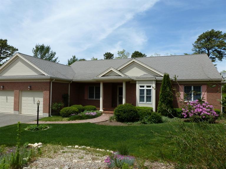 6 Penelope Road Bourne, MA 02532 - Photo 2 of 13 a front view of a house with garden