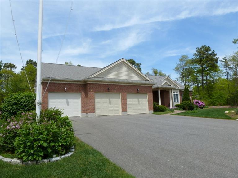 6 Penelope Road Bourne, MA 02532 - Photo 3 of 13 a front view of a house with a yard and garage