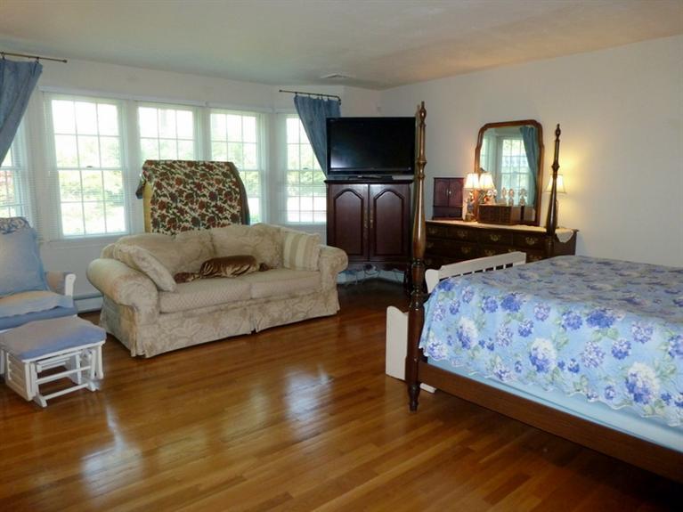 6 Penelope Road Bourne, MA 02532 - Photo 9 of 13 a bedroom with a bed and wooden floor
