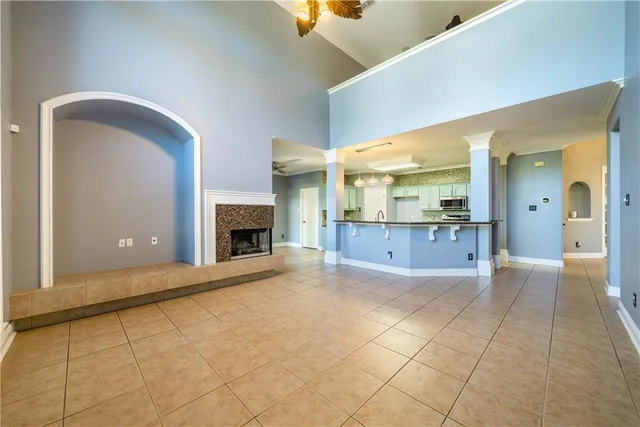 a view of an empty room with a fireplace and a window