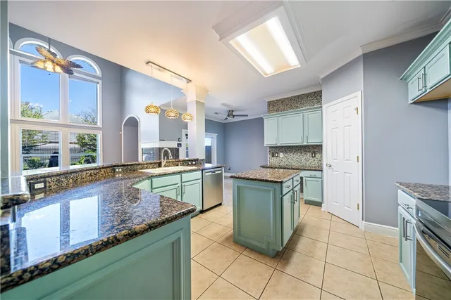 a kitchen with granite countertop a sink and a stove