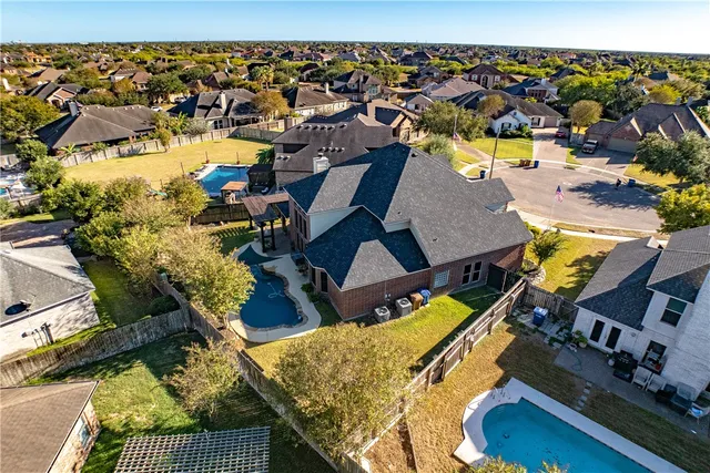 an aerial view of a house with a swimming pool