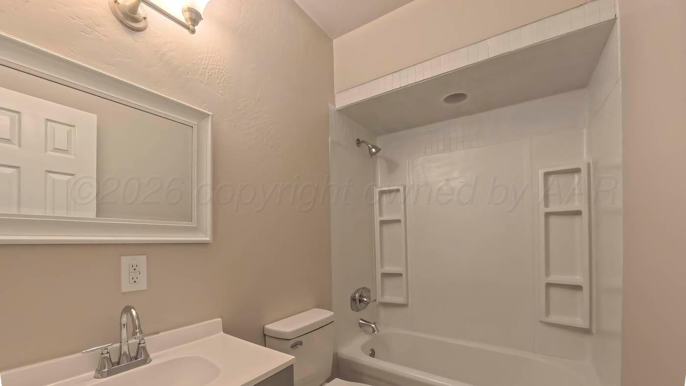 1316 Withers Avenue Amarillo, TX 79108 - Photo 15 of 19 a bathroom with a sink and a mirror