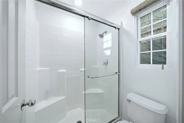 a bathroom with a shower and toilet