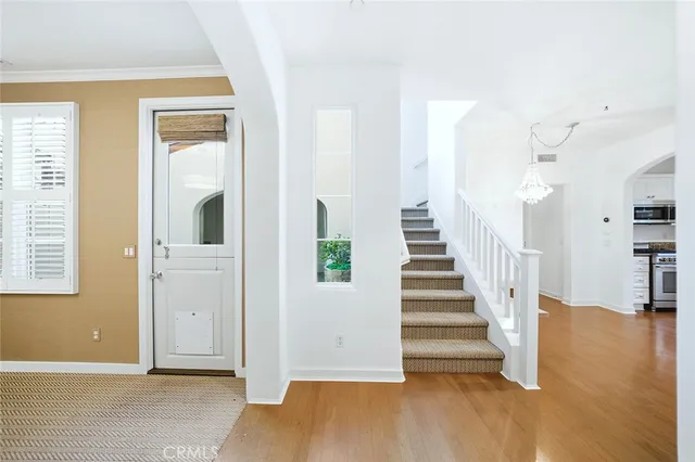 a view of entryway and hall with wooden floor
