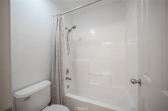 a bathroom with a shower and a toilet