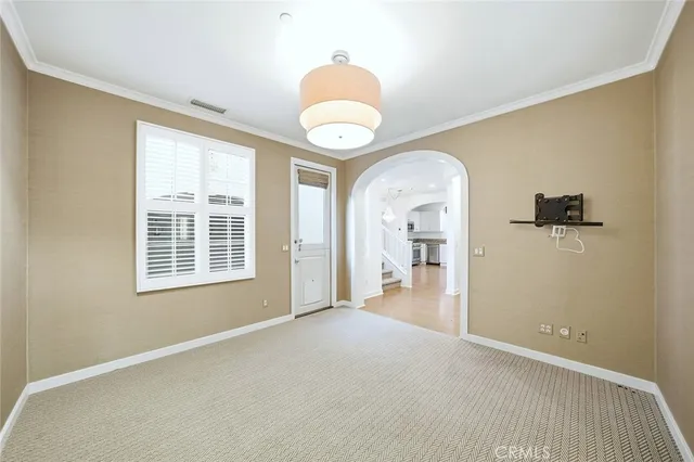 a view of a livingroom with wooden floor and a large window