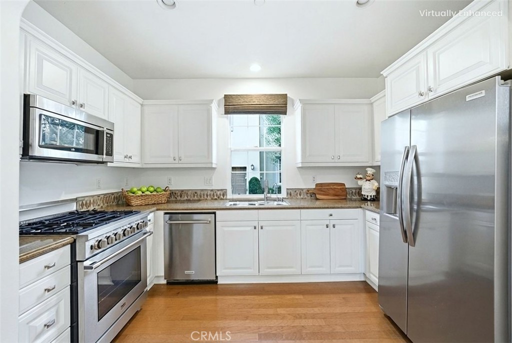 65 Greenhouse Irvine, CA 92603 - Photo 3 of 25 a kitchen with granite countertop a refrigerator stove top oven and sink